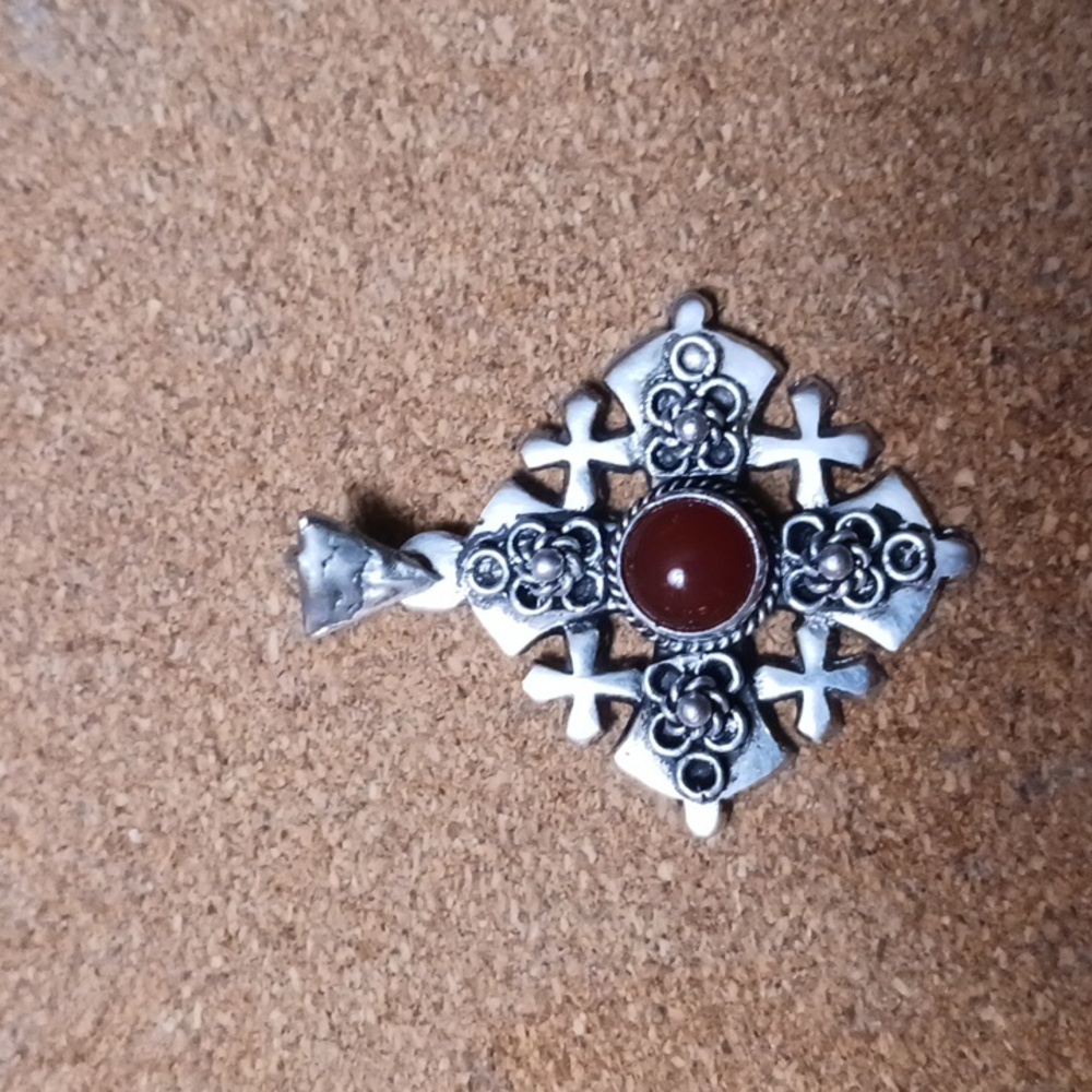 Cross pendant. Sterling silver with red stone.